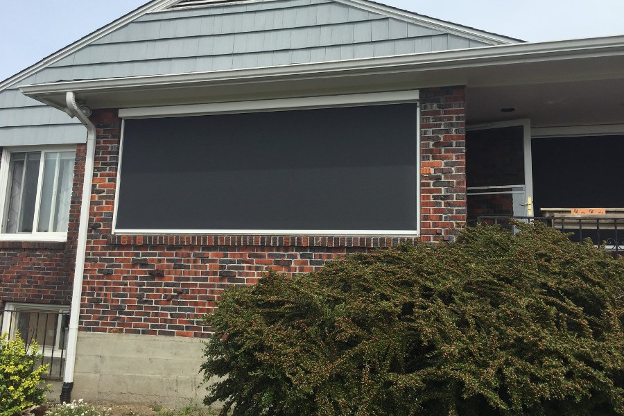 Large Motorized Exterior Shades Enclosed Between Brick Surround